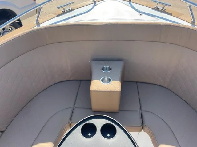 Slide: The Image of 2023 Maxima 620 Retro boat interior with beige seating and cup holders. - 11