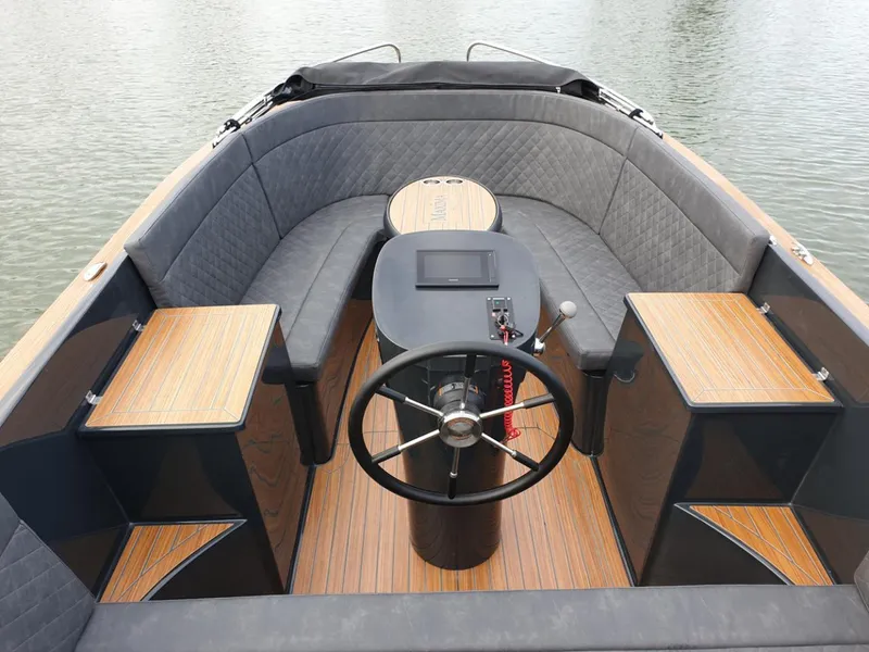 Slide: The Image of 2023 Maxima 620 Retro boat interior with wooden deck and cushioned seating. - 17