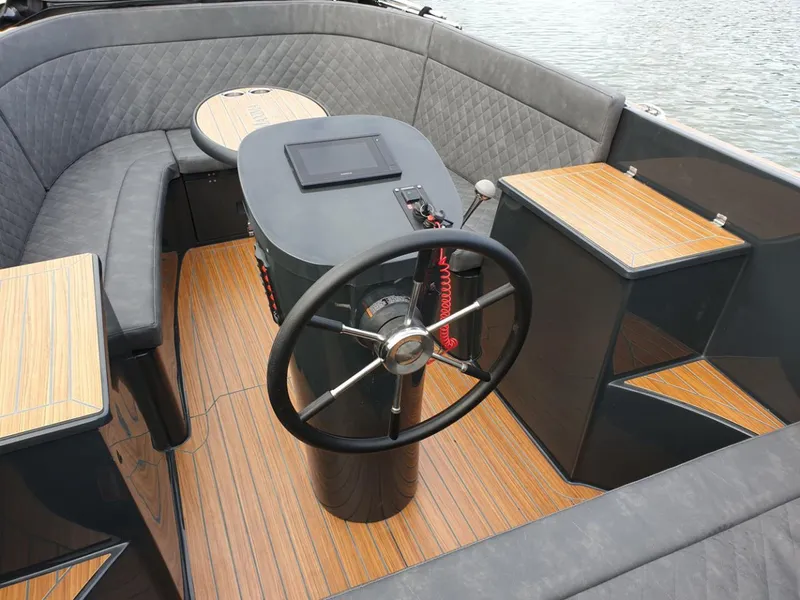 Slide: The Image of 2023 Maxima 620 Retro boat interior with steering wheel and wooden deck. - 18