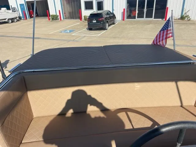 Slide: The Image of Maxima 620 Retro 2023 boat with tan interior and American flag in parking lot. - 19