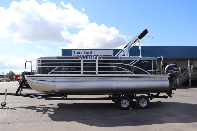 The Image of 2024 Bennington 20 SL pontoon boat on trailer, parked outdoors. - 0