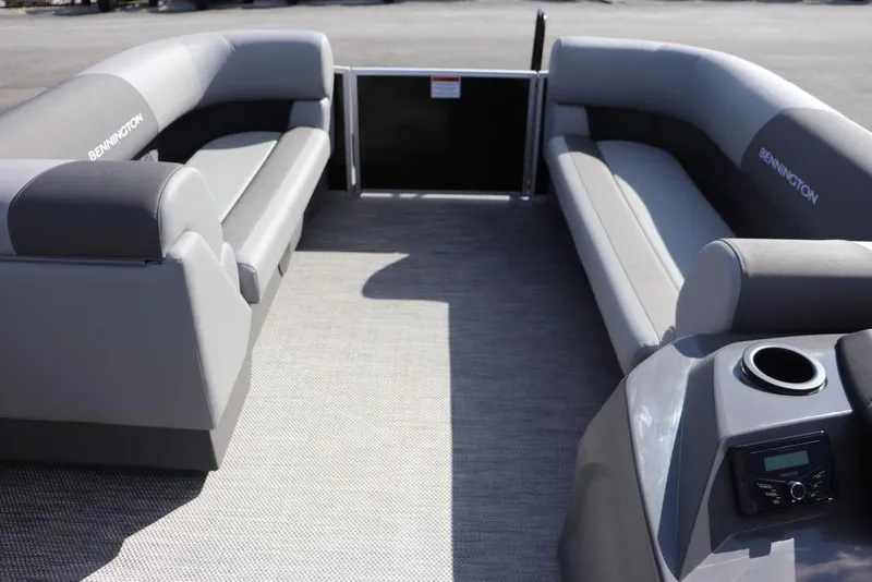 Slide: The Image of 2024 Bennington 20 SL pontoon boat interior with gray seating and console. - 2