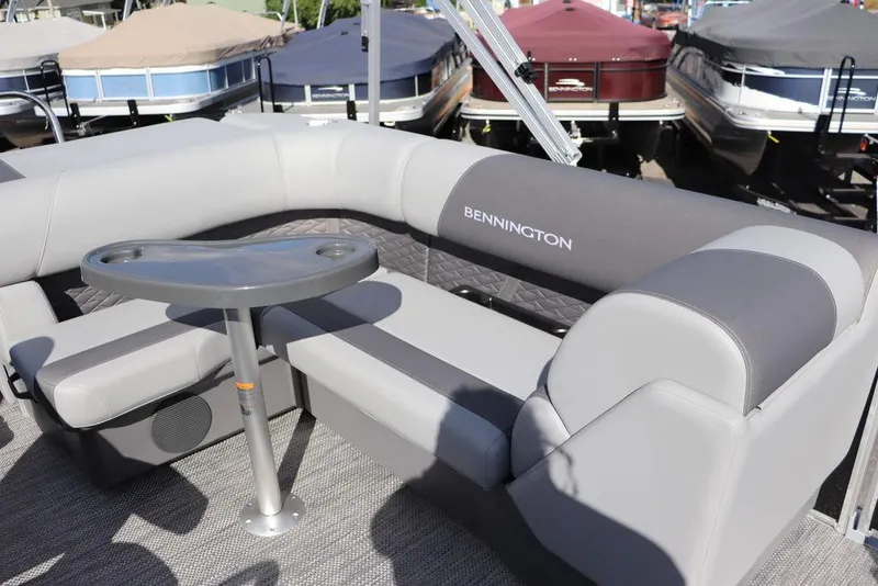 Slide: The Image of 2024 Bennington 20 SL pontoon boat with gray seating and table. - 3