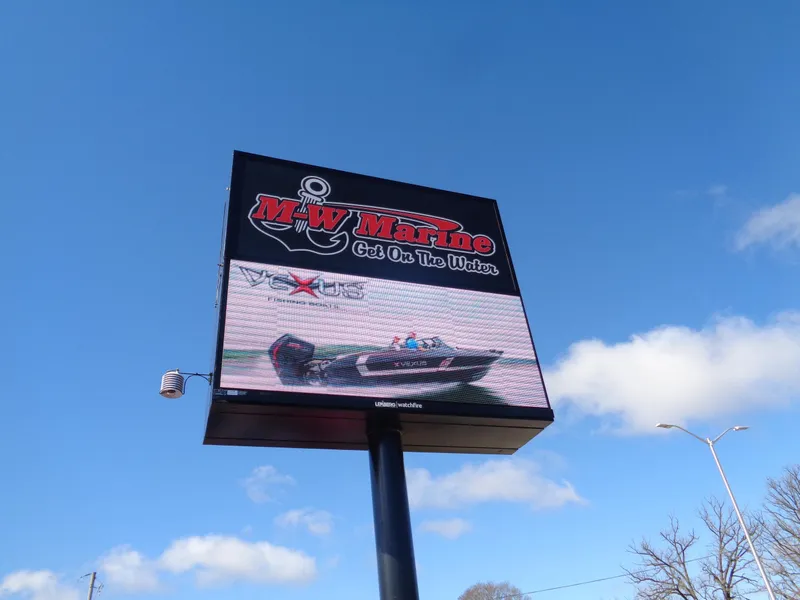 Slide: The Image of Outdoor sign for M-W Marine featuring a 2024 Lund 1600 Fury SS boat. - 11