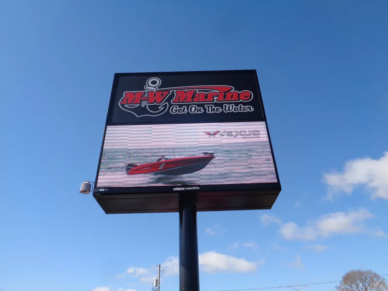 Slide: The Image of MW Marine billboard featuring 2024 Lund 1600 Fury SS boat under clear blue sky. - 12