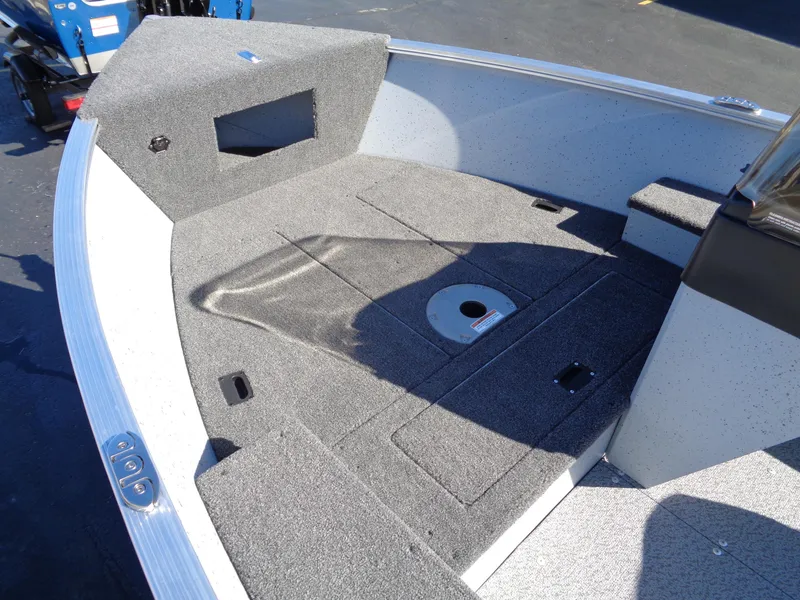 Slide: The Image of 2024 Lund 1600 Fury SS boat interior with carpeted deck and storage compartments. - 17