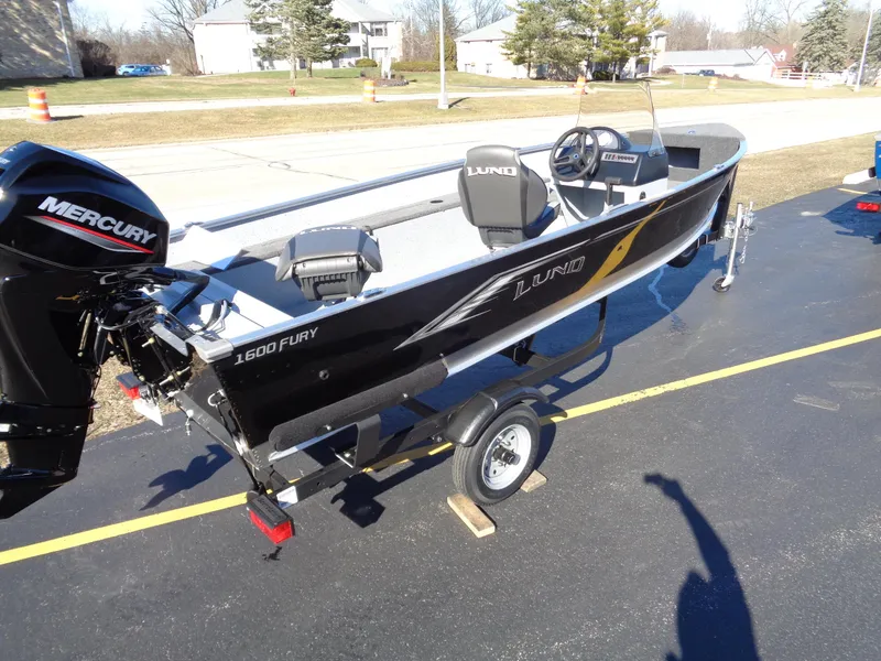 Slide: The Image of 2024 Lund 1600 Fury SS fishing boat on trailer with Mercury outboard motor. - 2