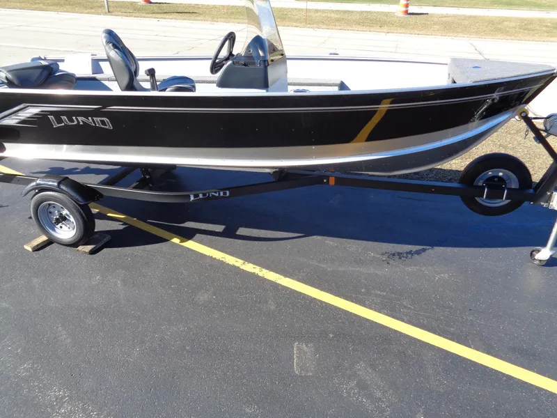 Slide: The Image of 2024 Lund 1600 Fury SS fishing boat on trailer, black and silver. - 3