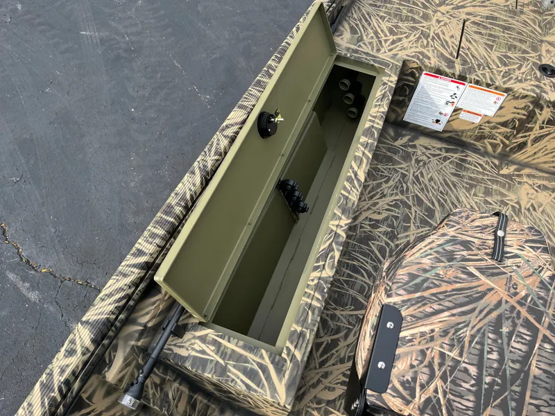 Slide: The Image of 2024 Lowe Roughneck 1660 boat with open storage compartment and camouflage design. - 13