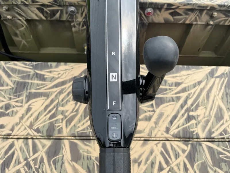 Slide: The Image of 2024 Lowe Roughneck 1660 boat throttle control with camouflage pattern. - 16