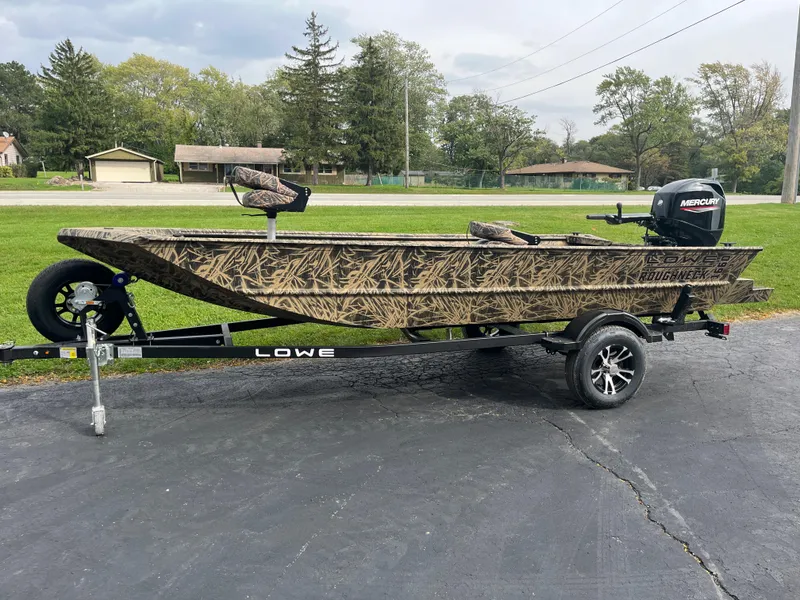 Slide: The Image of 2024 Lowe Roughneck 1660 boat on trailer with camouflage design and Mercury outboard motor. - 2