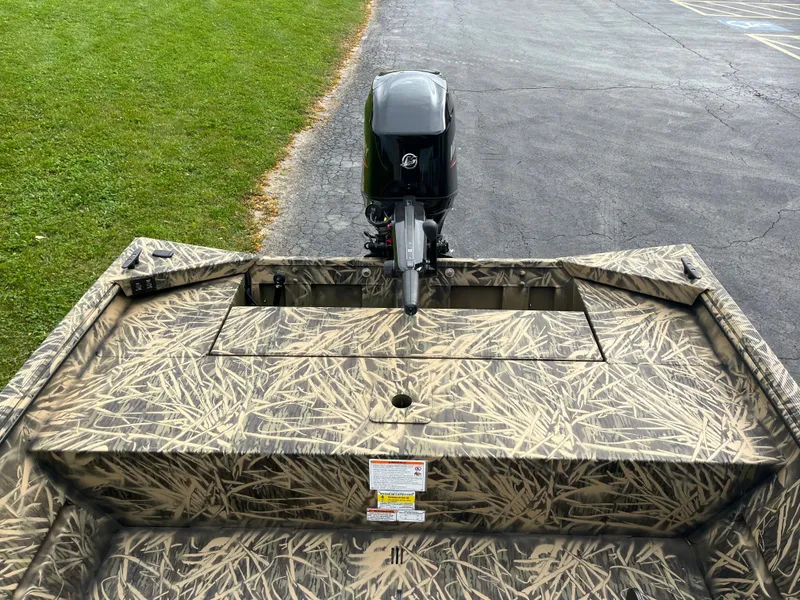 Slide: The Image of 2024 Lowe Roughneck 1660 boat with camouflage design and outboard motor. - 9