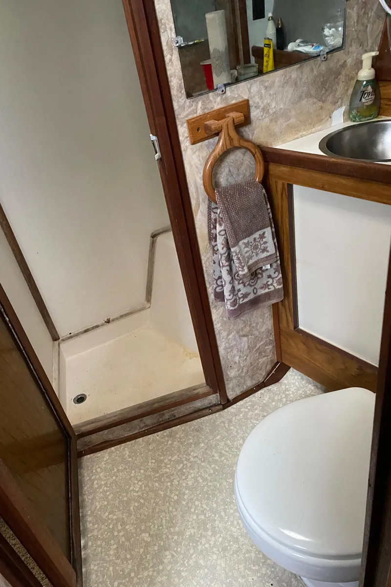 Slide: The Image of 1977 Jersey Dawn 40 boat bathroom with shower, sink, and toilet. - 11