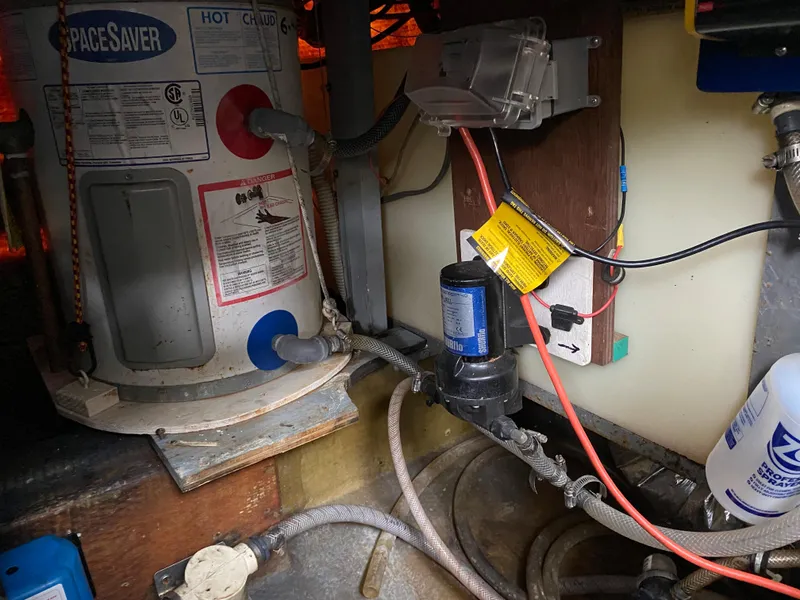 Slide: The Image of 1977 Jersey Dawn 40 boat engine room with SpaceSaver water heater and plumbing. - 18