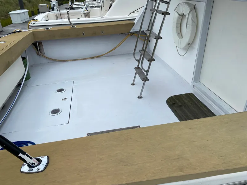 Slide: The Image of 1977 Jersey Dawn 40 boat deck with ladder and life ring. - 21