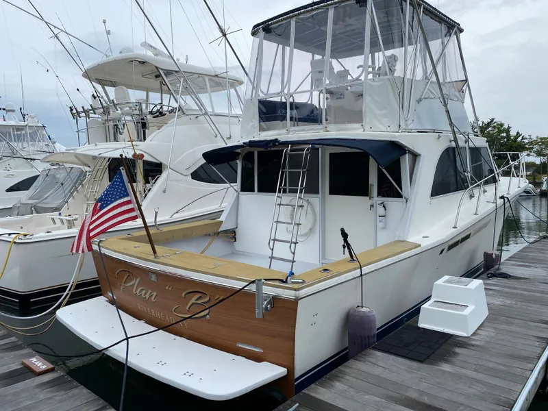 Slide: The Image of 1977 Jersey Dawn 40 yacht docked at marina with American flag. - 23