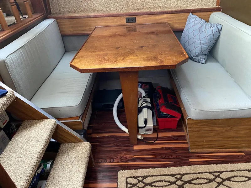 Slide: The Image of 1977 Jersey Dawn 40 boat interior with wooden table and cushioned seating. - 3