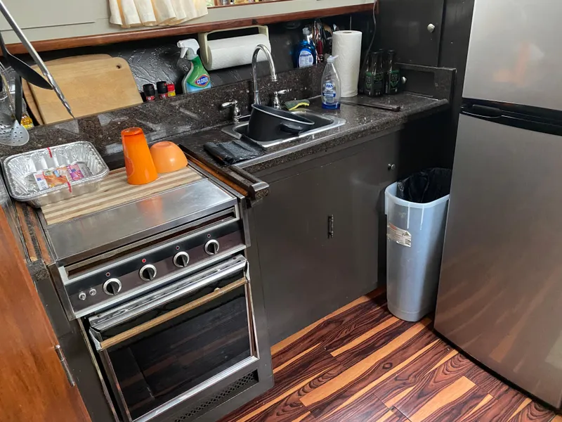 Slide: The Image of 1977 Jersey Dawn 40 boat kitchen with stove, sink, and refrigerator. - 5