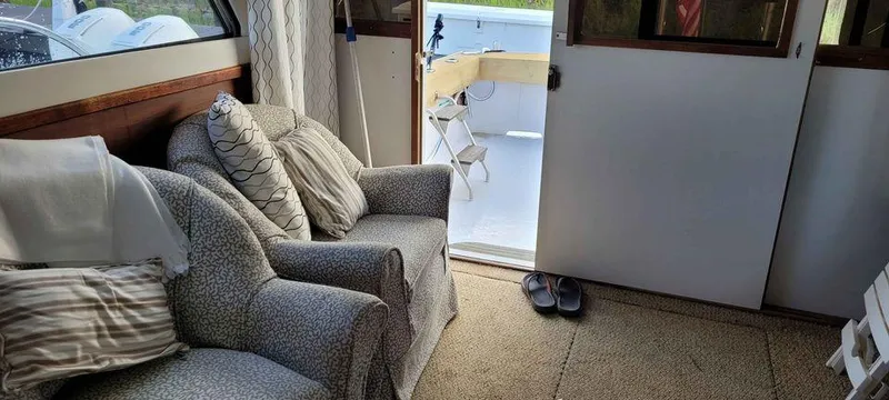 Slide: The Image of Interior of 1977 Jersey Dawn 40 boat with cozy seating area and open door to deck. - 8