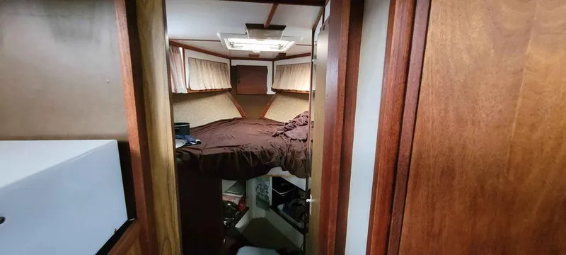 Slide: The Image of 1977 Jersey Dawn 40 boat cabin with bed and wooden interior. - 9