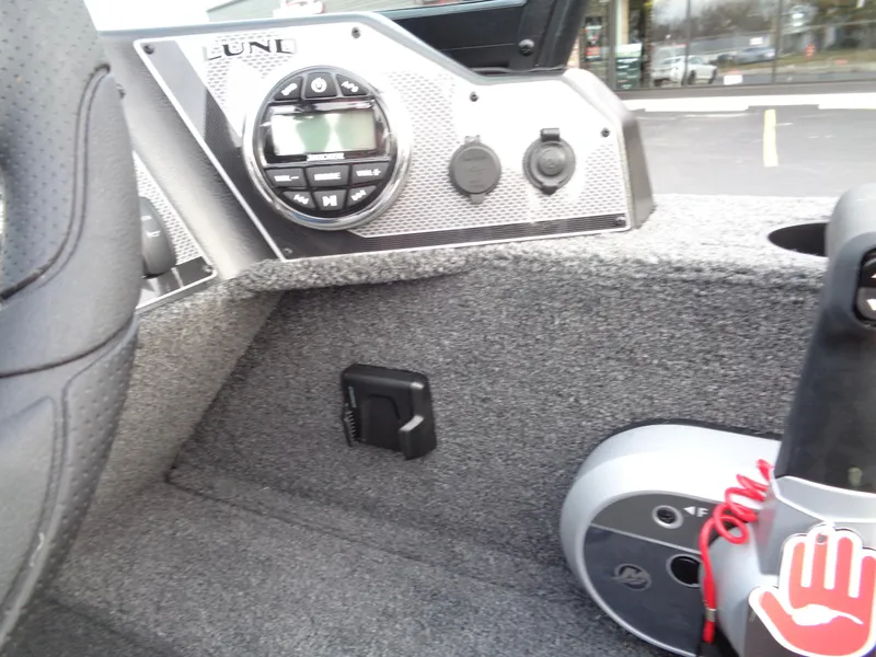 Slide: The Image of 2024 Lund 1650 Rebel XL Sport boat interior with control panel and audio system. - 13