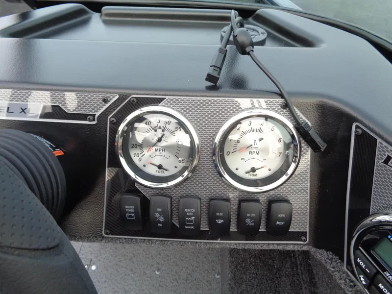 Slide: The Image of Dashboard of 2024 Lund 1650 Rebel XL Sport boat with gauges and controls. - 14