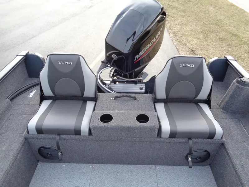 Slide: The Image of 2024 Lund 1650 Rebel XL Sport boat interior with dual seats and Mercury outboard motor. - 20