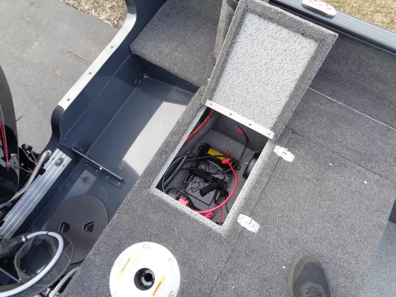 Slide: The Image of 2024 Lund 1650 Rebel XL Sport boat interior with open storage compartment. - 31