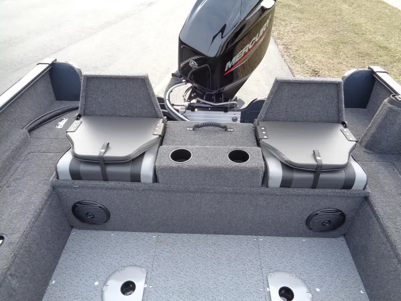 Slide: The Image of 2024 Lund 1650 Rebel XL Sport boat interior with Mercury engine, dual seats, and cup holders. - 32