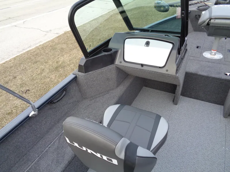 Slide: The Image of 2024 Lund 1650 Rebel XL Sport boat interior with seating and console. - 35