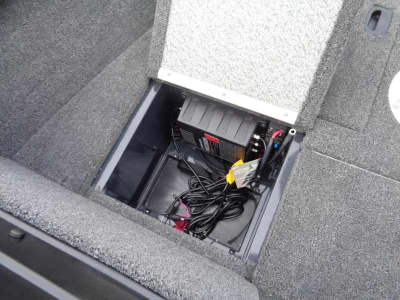Slide: The Image of 2024 Lund 1650 Rebel XL Sport storage compartment with battery and wiring. - 40