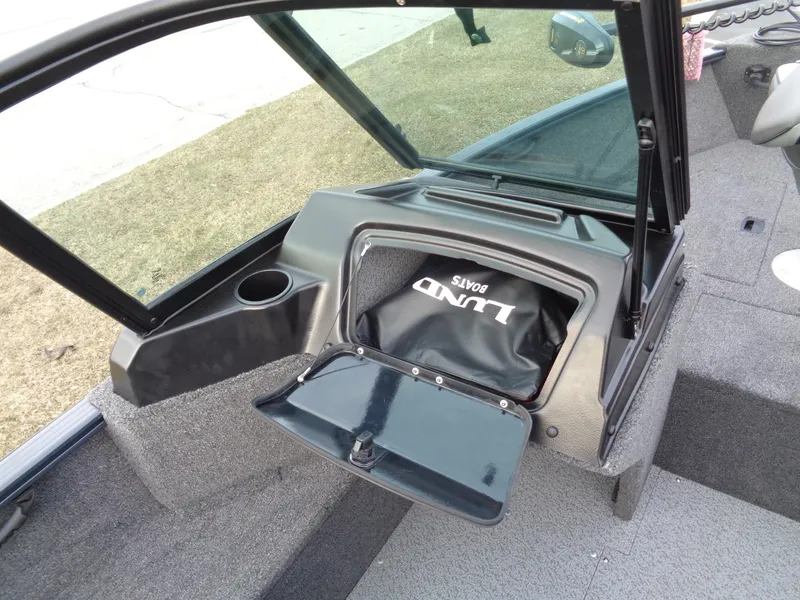 Slide: The Image of 2024 Lund 1650 Rebel XL Sport boat interior with storage compartment open. - 7