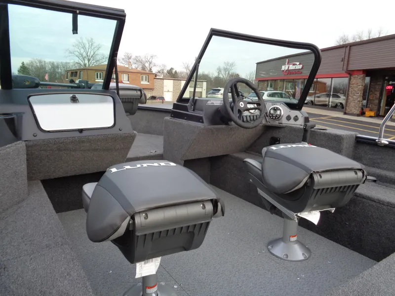 Slide: The Image of 2024 Lund 1650 Rebel XL Sport boat interior with dual seats and steering console. - 8