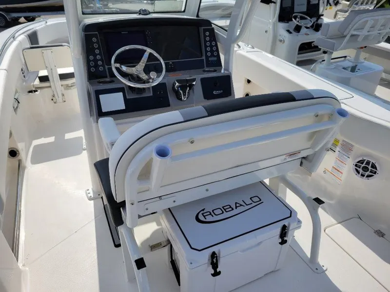 Slide: The Image of 2024 Robalo 250 CC boat interior with helm station and seating. - 14