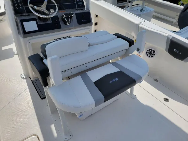 Slide: The Image of 2024 Robalo 250 CC boat interior with white and gray seating. - 16