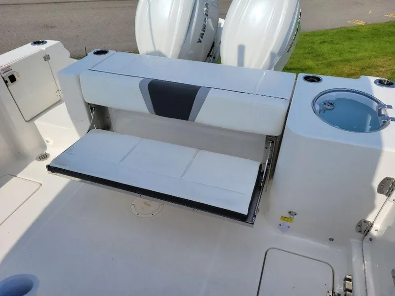 Slide: The Image of 2024 Robalo 250 CC boat with fold-down seat and twin outboard engines. - 18