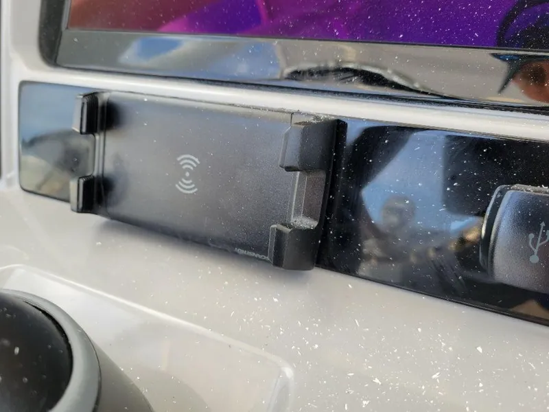 Slide: The Image of Close-up of the 2024 Robalo 250 CC dashboard with a wireless charging pad. - 19