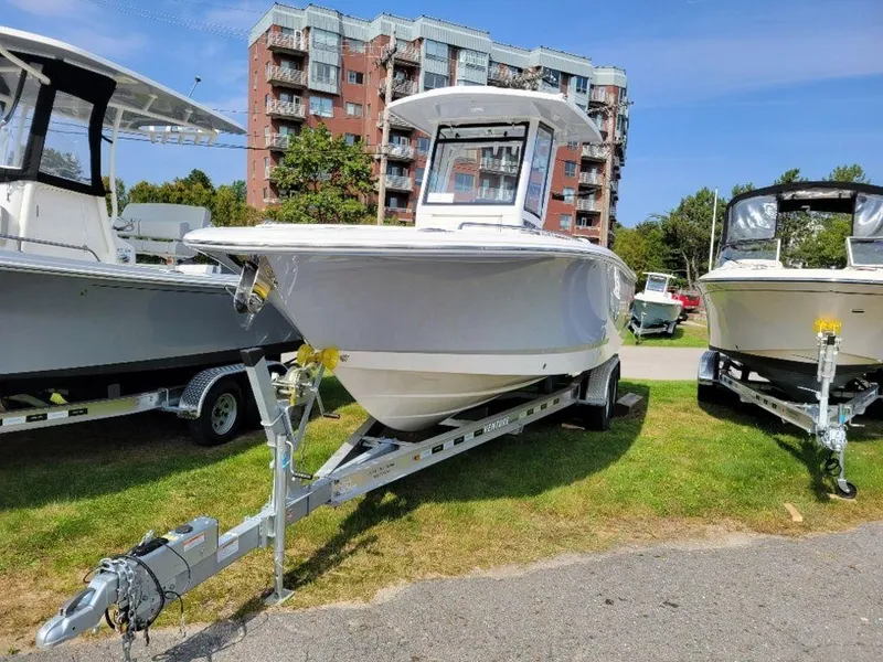 Slide: The Image of 2024 Robalo 250 CC boat on a trailer, displayed outdoors. - 2
