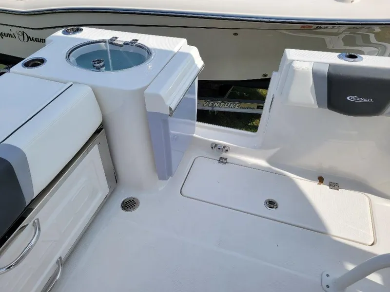 Slide: The Image of 2024 Robalo 250 CC boat interior with storage compartments and seating. - 22