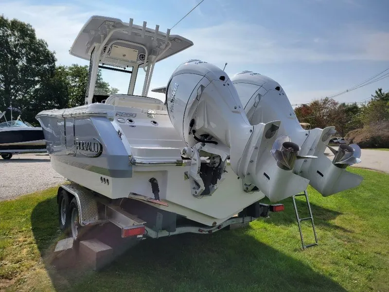 Slide: The Image of 2024 Robalo 250 CC boat with dual outboard engines on a trailer. - 3