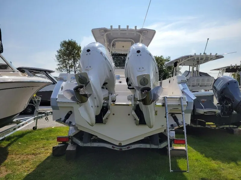 Slide: The Image of 2024 Robalo 250 CC boat with twin outboard engines, rear view. - 5