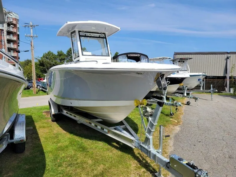 Slide: The Image of 2024 Robalo 250 CC boat on a trailer, displayed outdoors. - 6