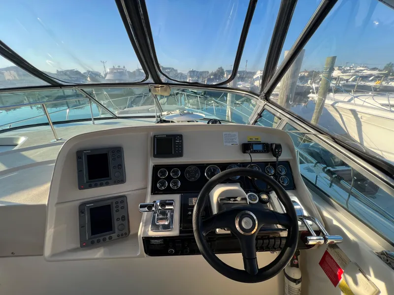 Slide: The Image of 1999 Cruisers Yachts 3575 Esprit helm with navigation instruments and steering wheel. - 14