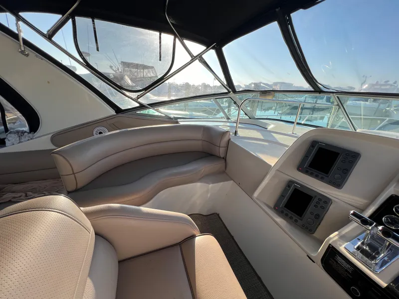 Slide: The Image of 1999 Cruisers Yachts 3575 Esprit cockpit with modern navigation equipment and comfortable seating. - 17