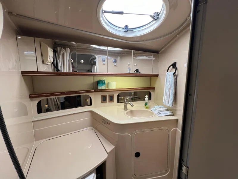 Slide: The Image of 1999 Cruisers Yachts 3575 Esprit bathroom with sink, mirror, and storage cabinets. - 24