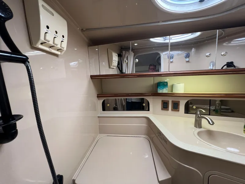 Slide: The Image of 1999 Cruisers Yachts 3575 Esprit bathroom with sink, mirror, and storage. - 26