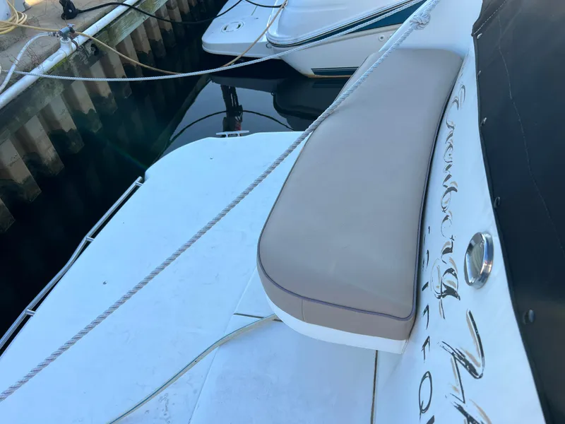 Slide: The Image of 1999 Cruisers Yachts 3575 Esprit docked, showing rear seating and deck area. - 38