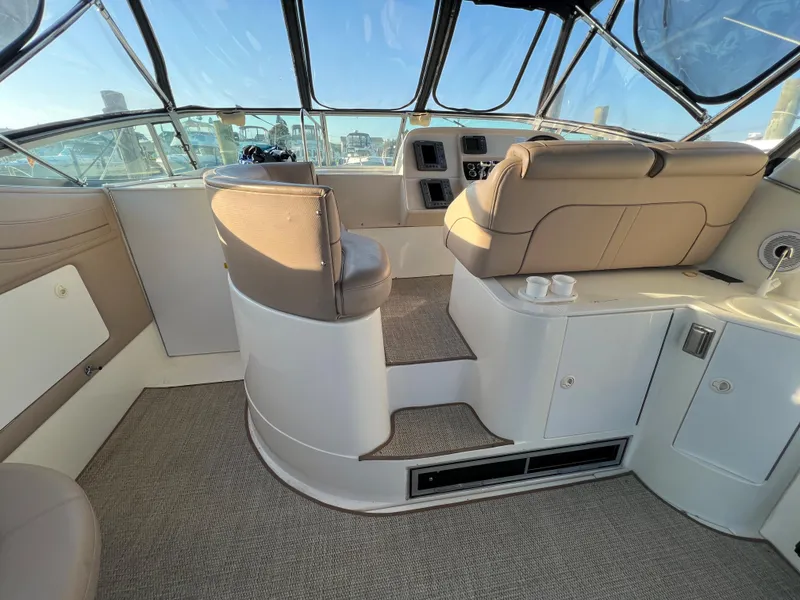 Slide: The Image of 1999 Cruisers Yachts 3575 Esprit helm station with seating and dashboard. - 4