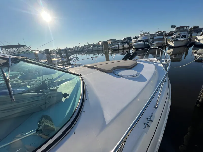 Slide: The Image of 1999 Cruisers Yachts 3575 Esprit docked at a marina under a bright sun. - 9