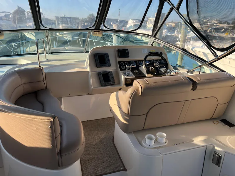 Slide: The Image of 1999 Cruisers Yachts 3575 Esprit cockpit with helm, seating, and controls. - 13